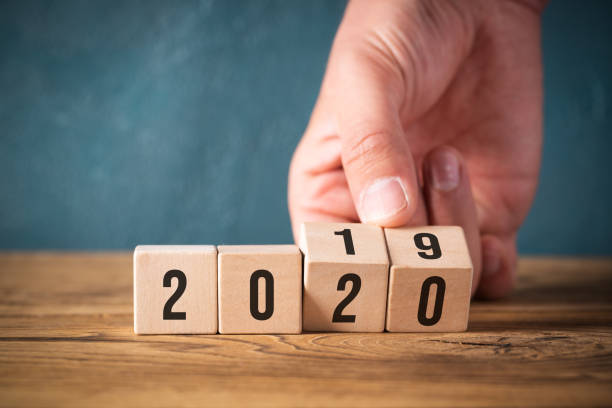 istock hand flipping cubes with year 2019 to 2020 1188009815