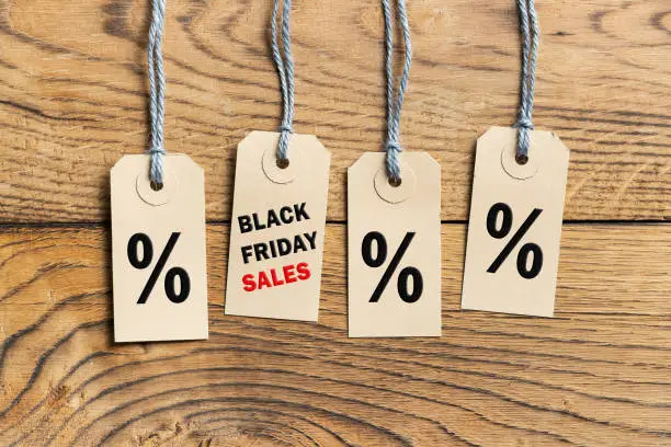 Hangtags with text "Black Friday" on wooden background