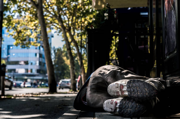 pauvre sans-abri ou réfugié dormant sur le plancher en béton de trottoir sur la rue urbaine dans la ville, concept de documentaire social, foyer sélectif - winter migration photos et images de collection