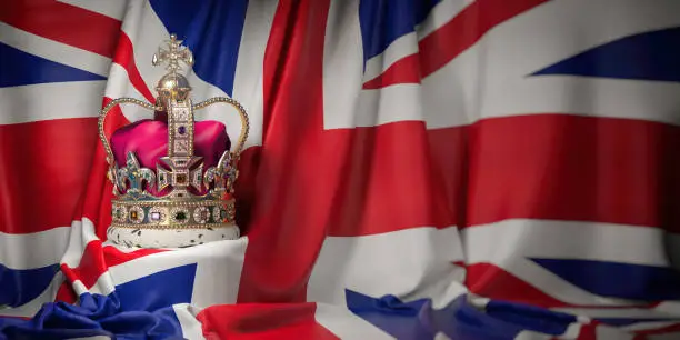 Photo of Royal golden crown with jewels on british  flag. Symbols of UK United Kingdom.