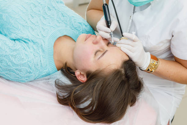 istock Permanent makeup, tattooing of eyebrows. Cosmetologist applying make up 1188013318
