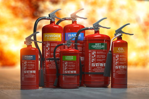Fire extinguishers on a fire background. Various types and different sizes of extinguishers. 3d illustration Fire extinguishers on a fire background. Various types and different sizes of extinguishers. fire extinguisher photos stock pictures, royalty-free photos & images