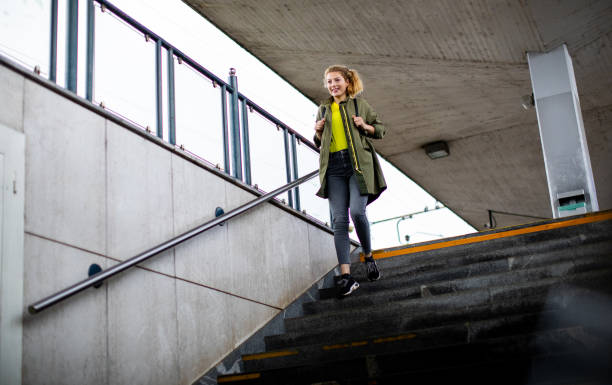 istock Young Woman Moving down The Stairs at Train Station 1188014564