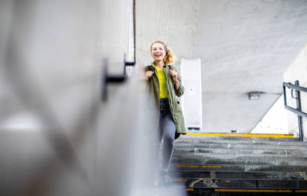 istock Young Woman Moving down The Stairs at Train Station 1188015109