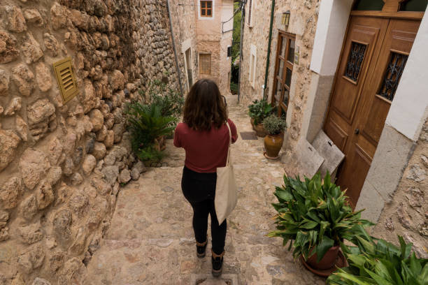 istock Young spanish girl lwalking in a ancient village 1188015170