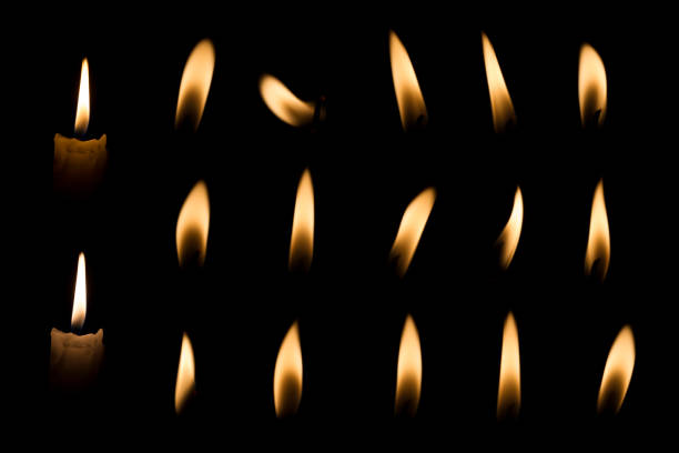 jogo da chama da vela - lighting equipment illuminated isolated on black part of - fotografias e filmes do acervo