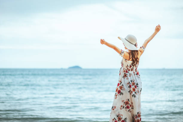 istock Travel woman walking on beach 1188016166