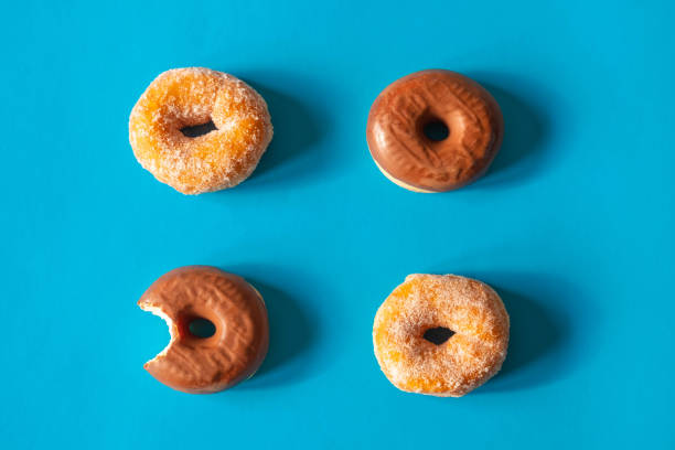 istock Sugar coated donuts and donuts with chocolate frosting with one donut bitten 1188016250