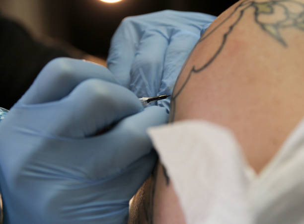 istock Professional tattoo artist doing tattoo in studio 1188016500