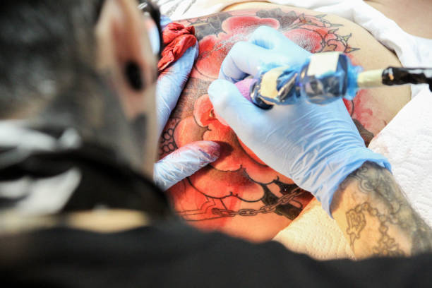 istock Professional tattoo artist doing tattoo in studio 1188016501