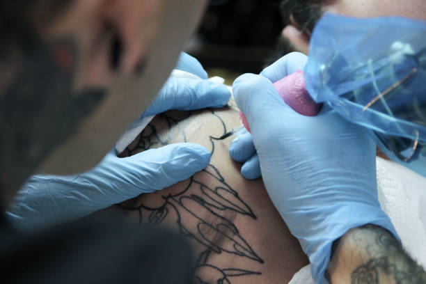 istock Professional tattoo artist doing tattoo in studio 1188016507