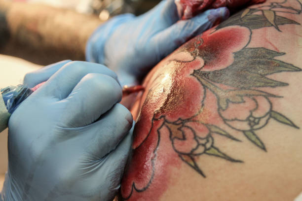 istock Professional tattoo artist doing tattoo in studio 1188016526