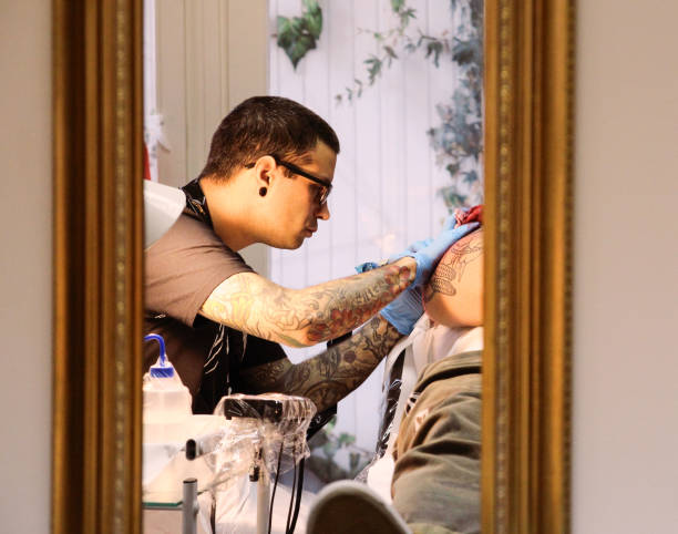 istock Professional tattoo artist doing tattoo in studio 1188016528
