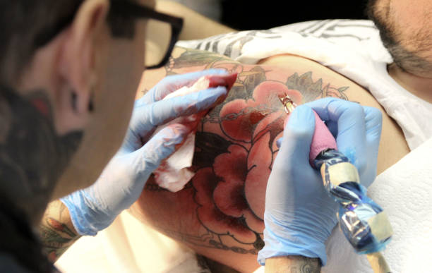 istock Professional tattoo artist doing tattoo in studio 1188016530