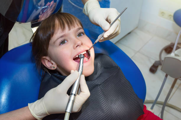 istock A dentist examining a child’s teeth in the dentistry 1188018522