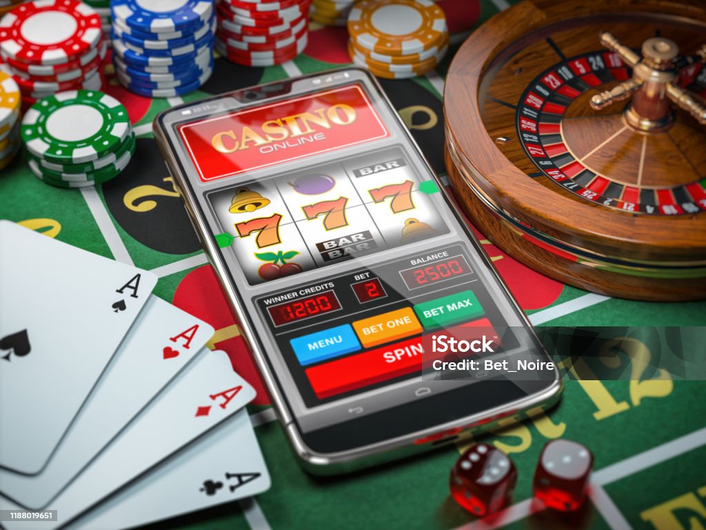 Casino online. Smartphone or mobile phone, slot machine, dice, cards and roulette on a green table in casino. Casino online. Smartphone or mobile phone, slot machine, dice, cards and roulette on a green table in casino. 3d illustration Internet Stock Photo