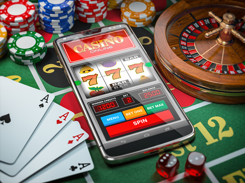 Casino Online Smartphone Or Mobile Phone Slot Machine Dice Cards And  Roulette On A Green Table In Casino Stock Photo - Download Image Now -  iStock
