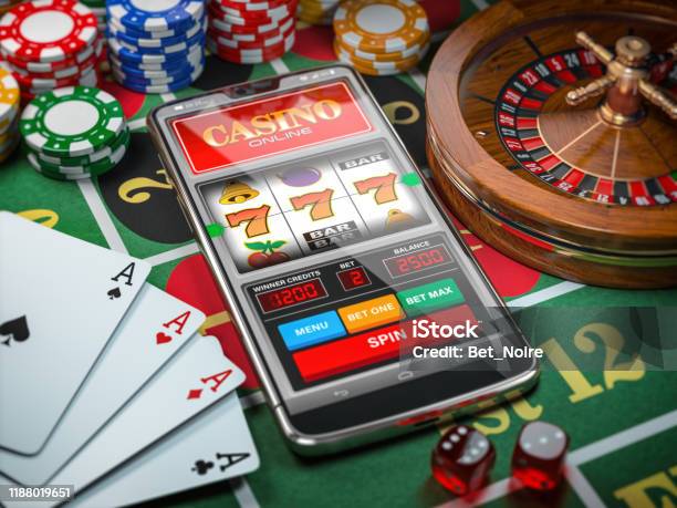 Casino Online Smartphone Or Mobile Phone Slot Machine Dice Cards And Roulette On A Green Table In Casino Stock Photo - Download Image Now