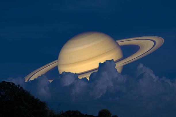 istock Saturn on night sky back silhouette mountain and heap cloud 1188021744