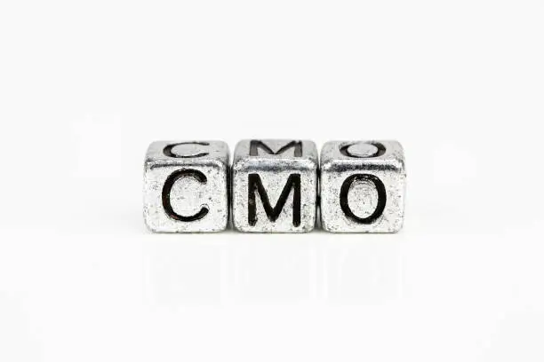 Photo of Chief Marketing Officer CMO concept with cubic metal letters