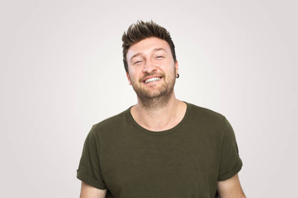 istock Laughing  handsome young man over isolated  gray background 1188024590