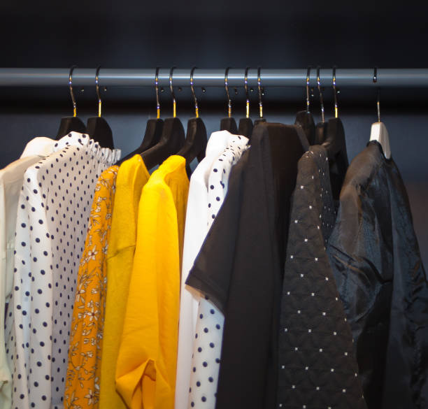istock Different colors clothes hanging on a rack 1188024712