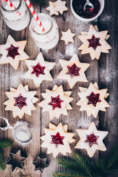 istock Linzer Christmas cookies filled with raspberry jam on wooden background. 1188025703