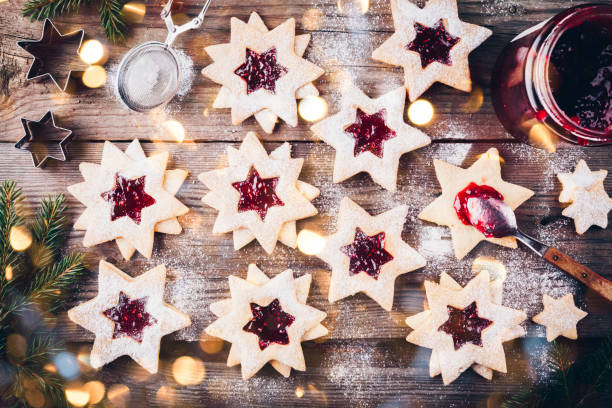 istock Linzer Christmas cookies filled with raspberry jam on wooden background. 1188025722