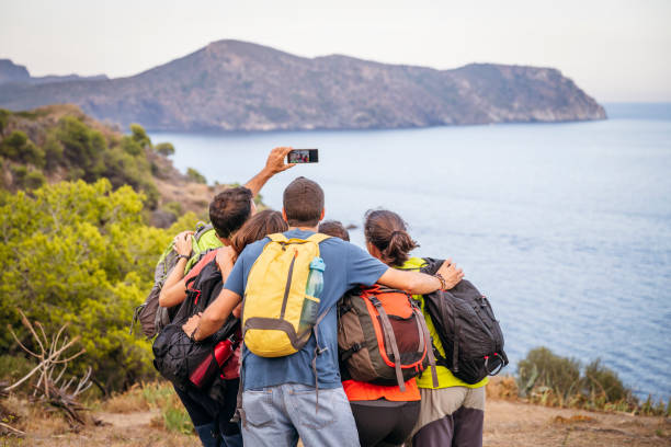 istock Huddled group of backpackers taking selfie on coastal trail 1188026022