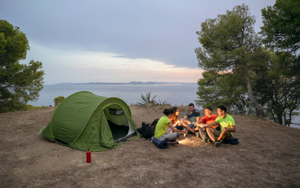 istock Friends enjoying coffee at campsite with Mediterranean view 1188026054