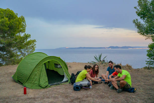 istock Spanish hikers sharing smart phone photos at campsite 1188026056