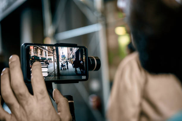 istock Man doing live video with phone with stabilizer  in NY 1188030194
