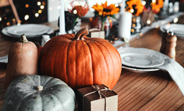 It wouldn't be Thanksgiving without you Shot of a table set up for a Thanksgiving celebration at home pumpkin decorating stock pictures, royalty-free photos & images