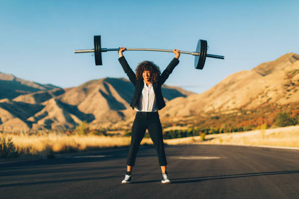 istock Businesswoman Lifting Weights 1188030600