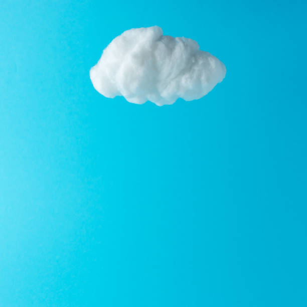 istock White cotton cloud against pastel blue background. Minimal concept. 1188031811