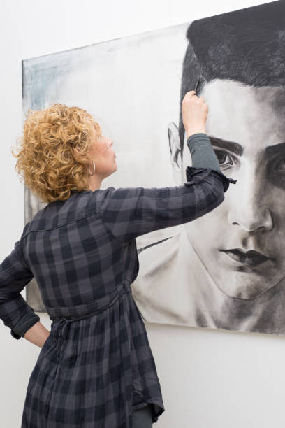 istock Female painter painting portrait 1188032453