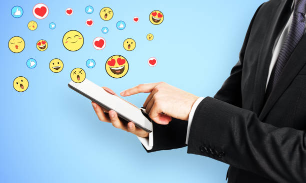 istock Hand with cellphone and smileys 1188032967