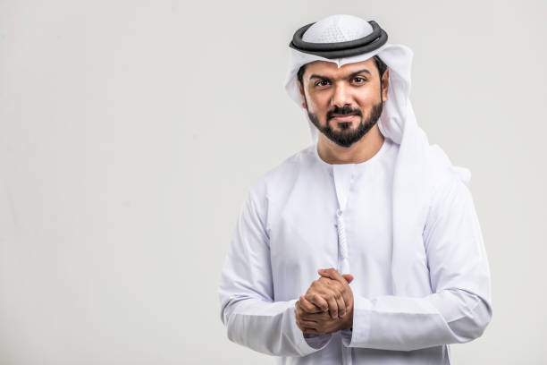 Arabian man with traditional dress Portrait of arabic man with kandora in a studio emirati culture photos stock pictures, royalty-free photos & images