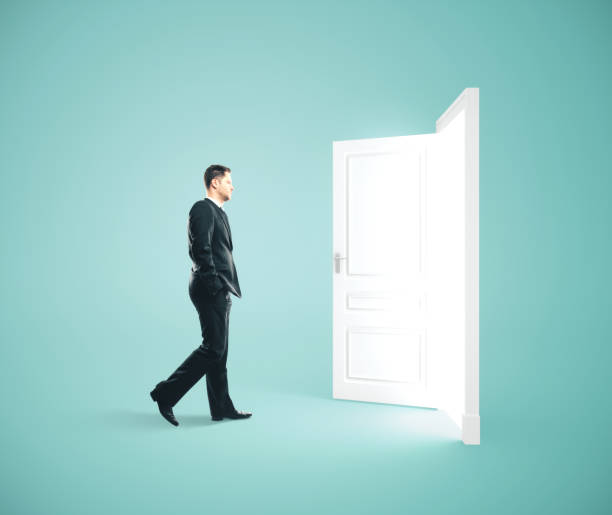 Businessman walking to opened door.
