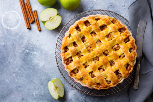 istock Apple pie with caramel sauce on a cooling rack. Grey background. Copy space. Top view. 1188036002