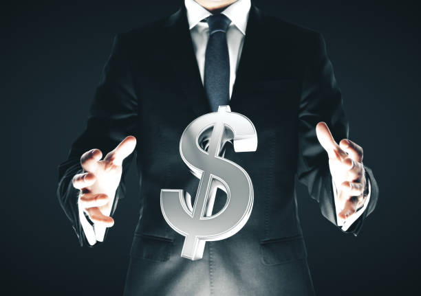 istock Businessman holding dollar sign 1188036117