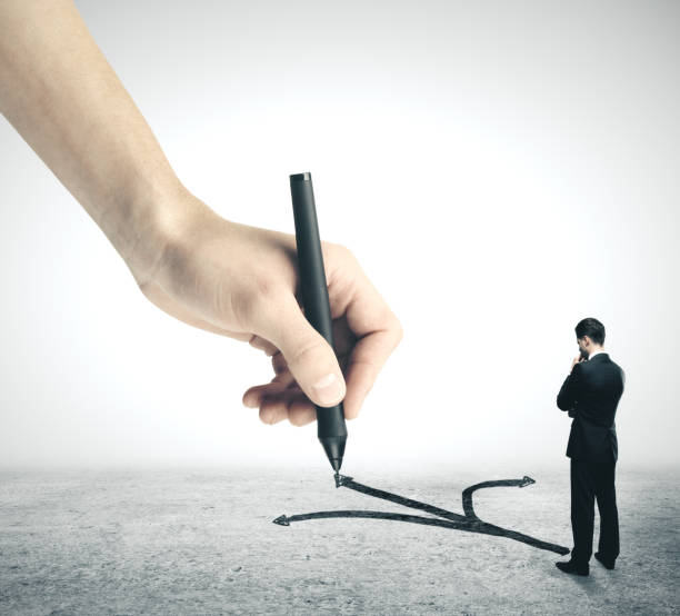 istock Businessman standing on drawing arrows 1188036175