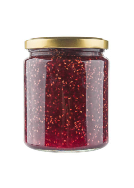 Jar of raspberry jam isolated on white background