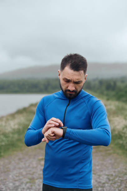 istock Handsome bearded man checking up his smart watch 1188036331