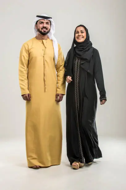 Photo of ARabian couple isolated on grey background