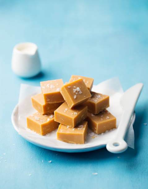 istock Fresh caramel fudge candies on a plate. Blue background. Copy space. 1188038079