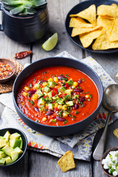 istock Mexican soup. Tomato, bean, bell pepper in black bowl. 1188038300
