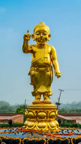 Photo of Golden Sculpture of Lord Buddha as baby in Lumbini, Nepal