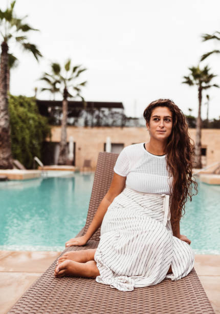 istock woman resting on the pool 1188038498