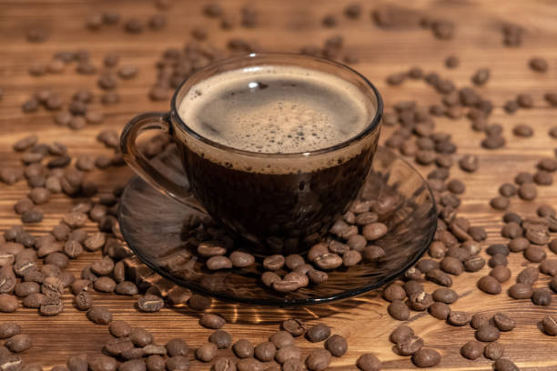 istock Coffee cup and coffee beans on wooden table. Selective focus 1188038523